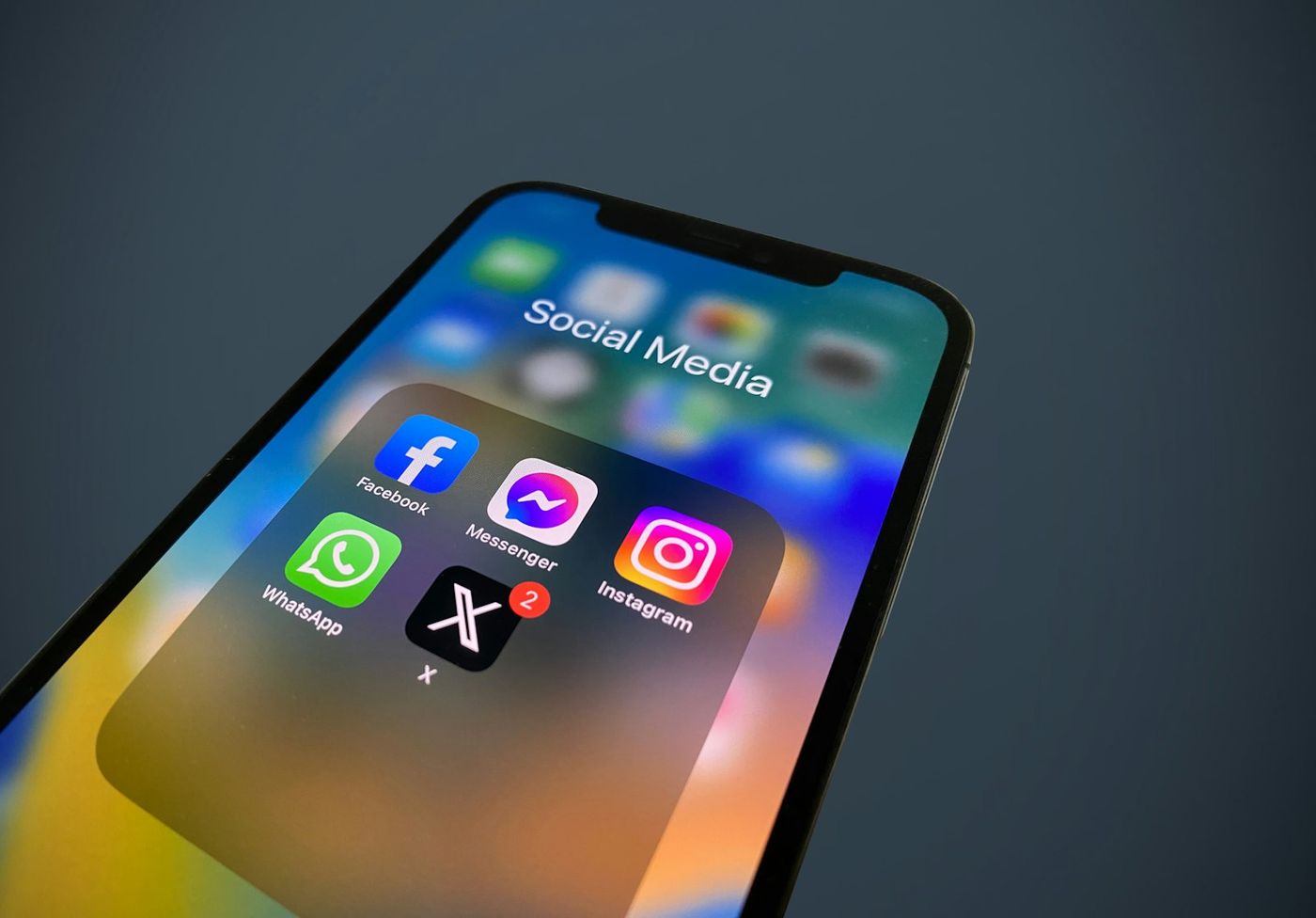 Close-up of a phone screen showing a folder of social media app icons